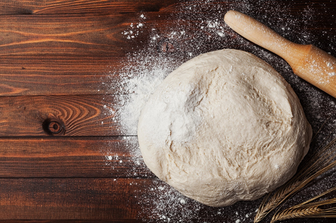 Pizza dough and a rolling pin