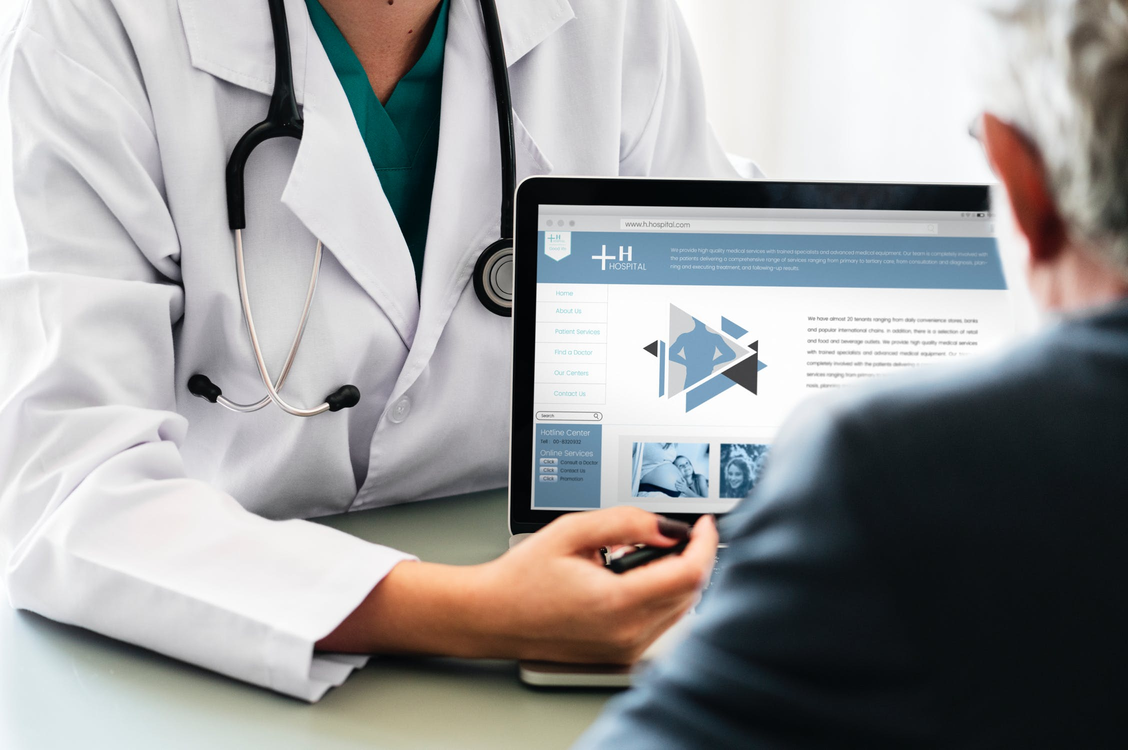 A doctor showing a patient something on a laptop screen