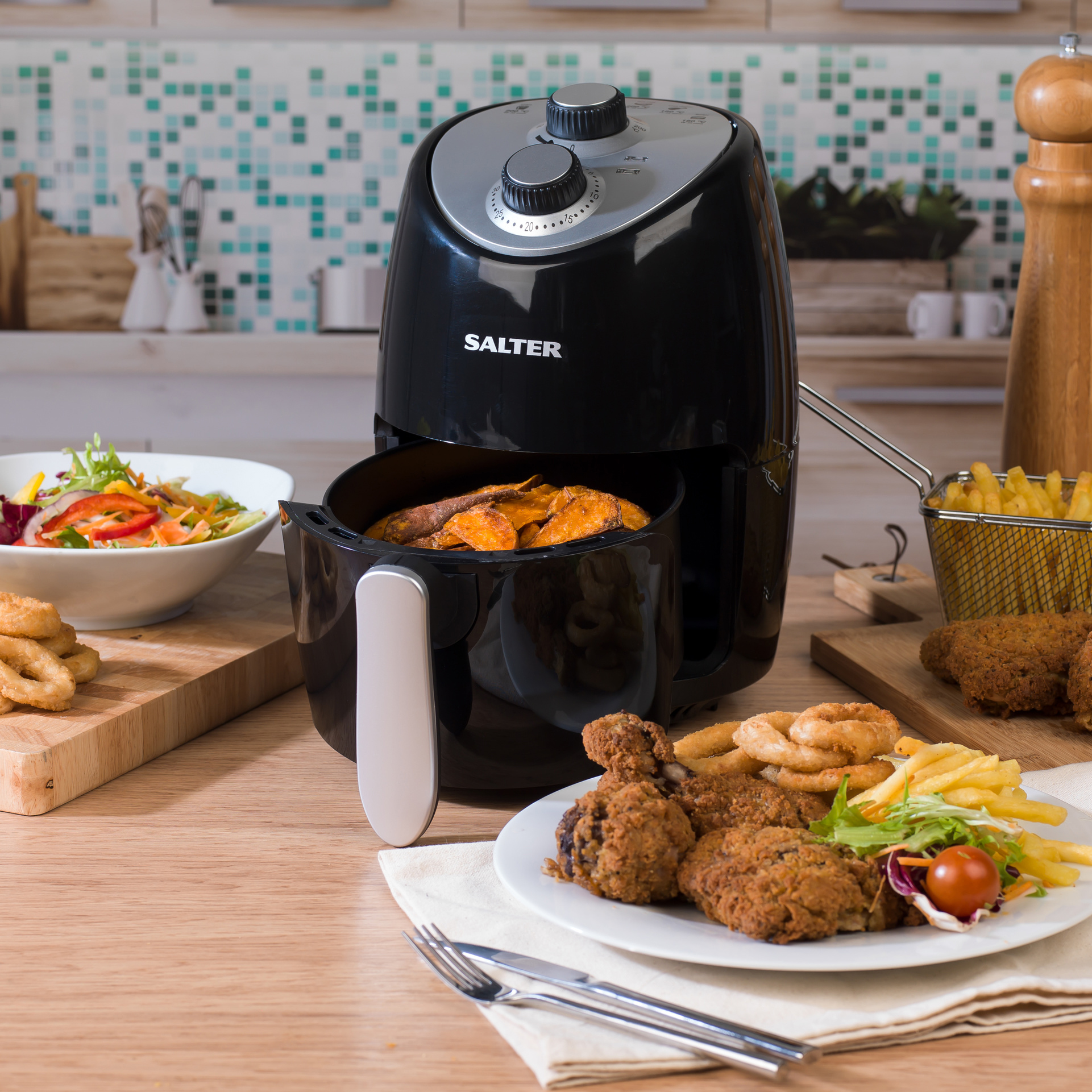 A Salter Compact Hot Air Fryer open with Chicken on a plate