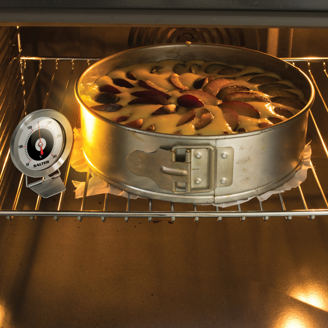 Salter oven thermometer next to a cake being baked in an oven
