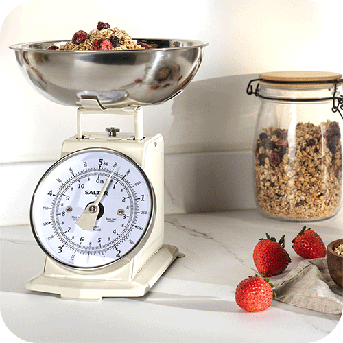 Salter timless mechanical scale being used with granola